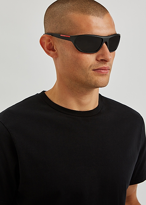 Prada Linea Rossa Matte black wrap-around sunglasses - Harvey Nichols